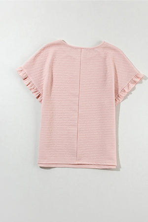 Blush pink textured top with ruffle short sleeves and a round neckline.