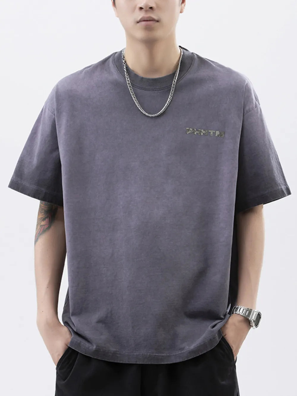 Men's dark gray cotton t-shirt with a subtle letter graphic and round neck.