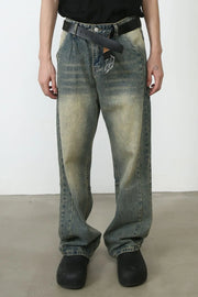 Faded wash baggy carpenter jeans in medium with a distressed look and a black belt.