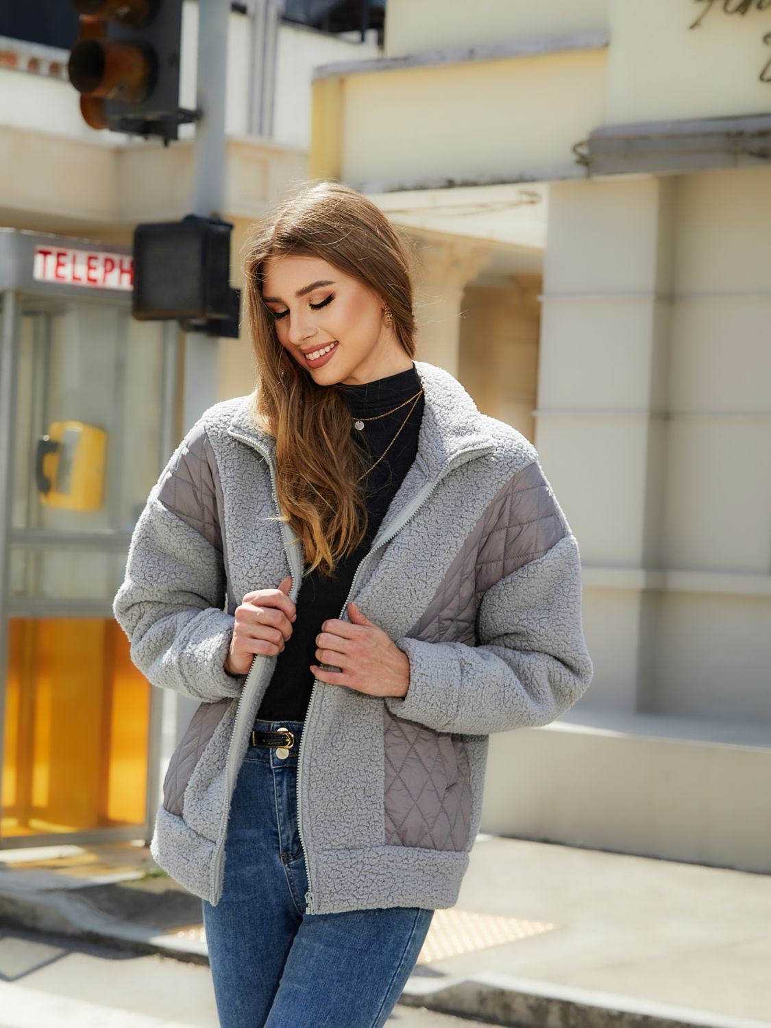 Gray quilted and sherpa panel zip jacket with a stand-up collar.