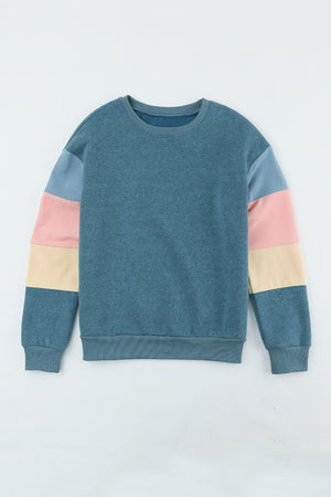 French blue sweatshirt with color block sleeves in pink, cream, and light blue.