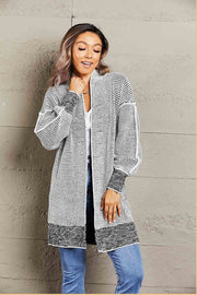 Textured puff sleeve open cardigan in black and white with a contrasting hem and cuffs.