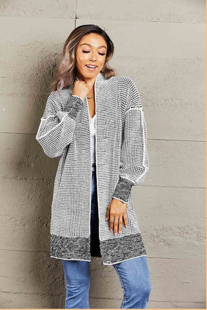 Textured puff sleeve open cardigan in black and white with a contrasting hem and cuffs.