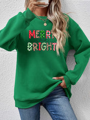 Green crewneck sweatshirt with "Merry and Bright" graphic in festive patterns.