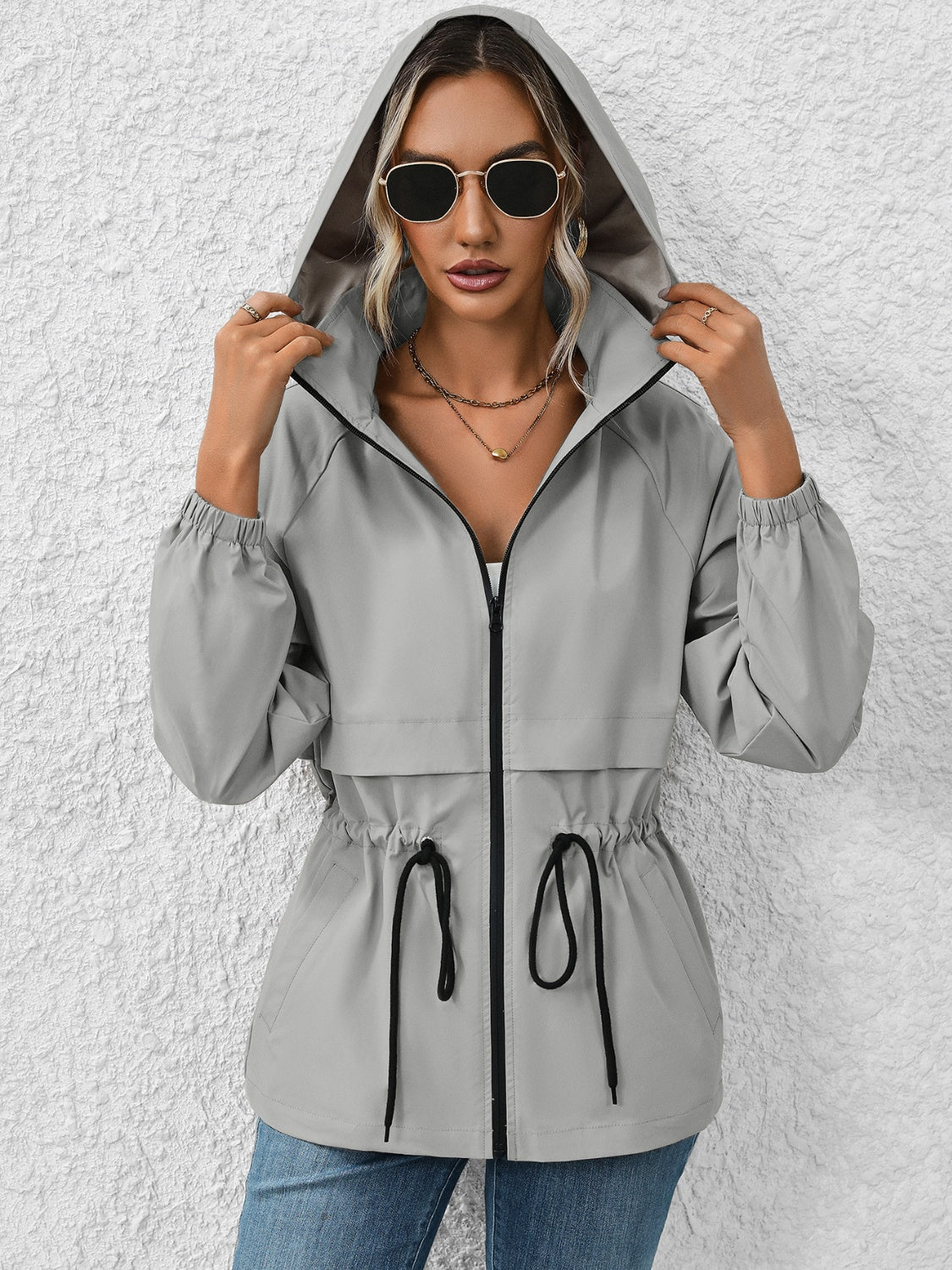 Gray hooded utility jacket with cinched waist and drawstring detail