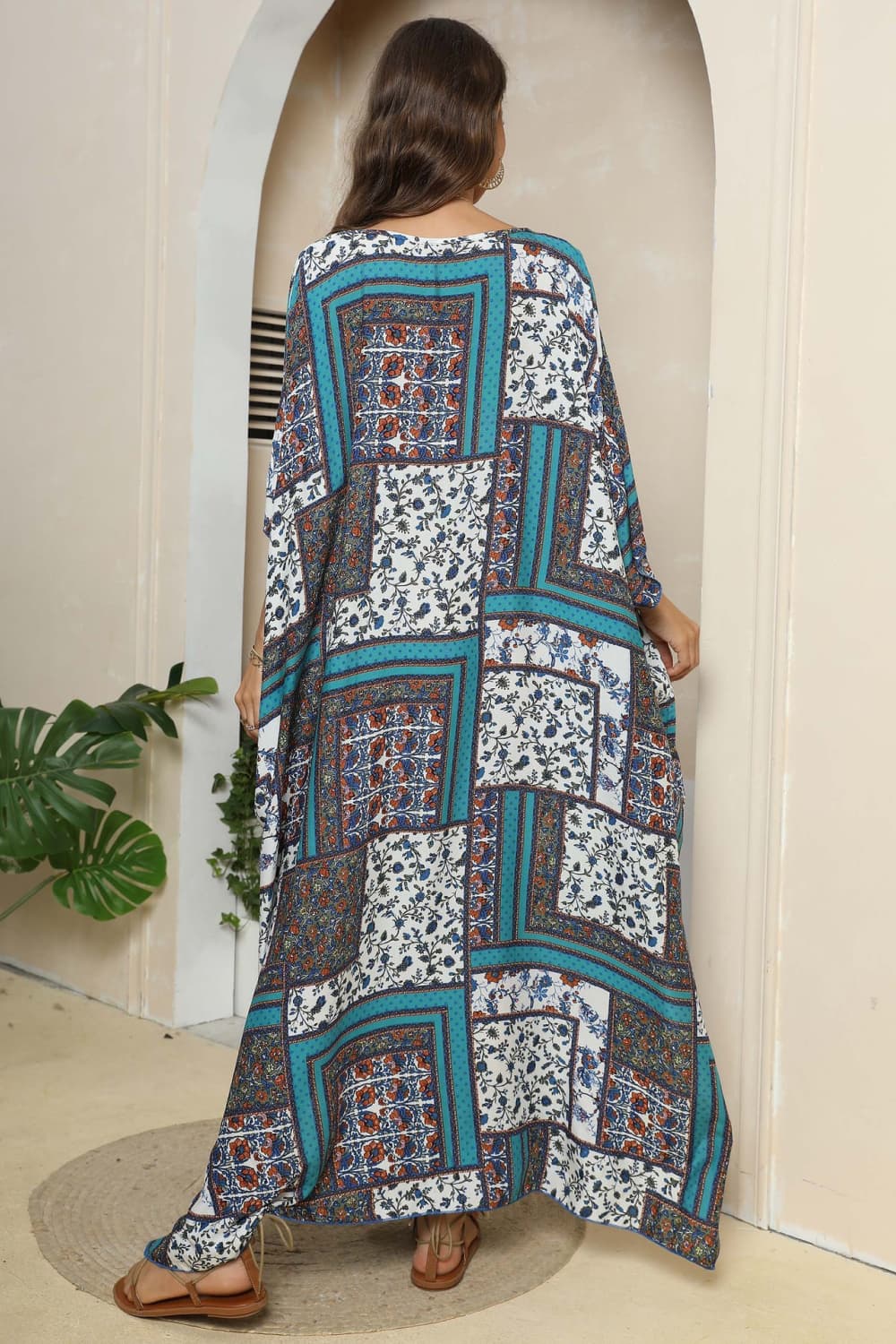 Patchwork caftan maxi dress in teal with floral prints and wide sleeves.