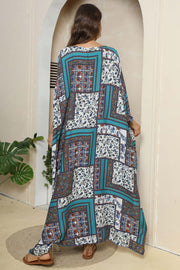 Patchwork caftan maxi dress in teal with floral prints and wide sleeves.