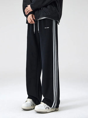 Black wide-leg sweatpants with white side stripes and drawstring waist.
