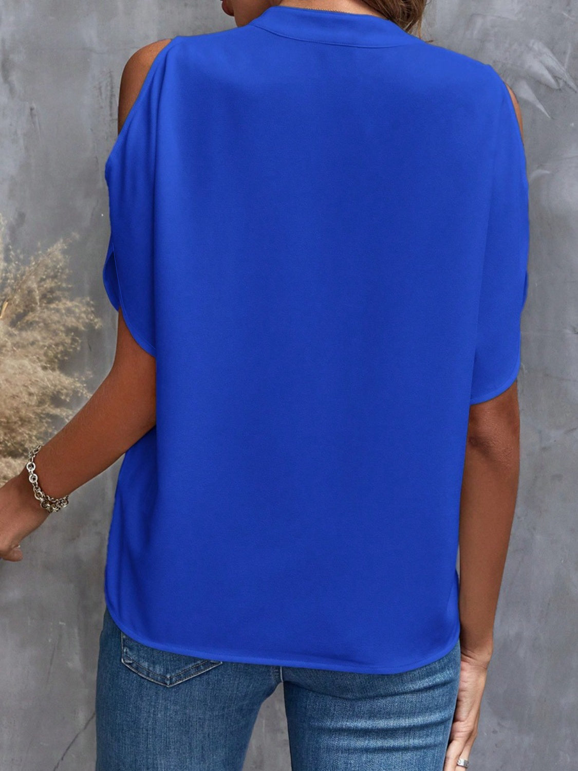 Royal blue polyester open-shoulder blouse with short sleeves and a keyhole detail.