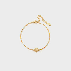 Gold enamel bead bracelet with lotus charm and adjustable clasp