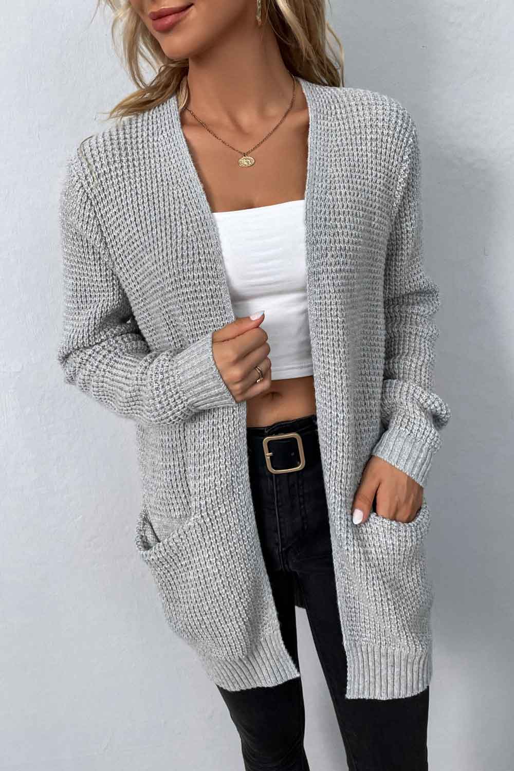 Light gray waffle knit longline cardigan with pockets, open front and long sleeves.