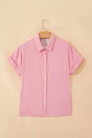 Pink polka dot button-up shirt with short sleeves and a collared neckline.