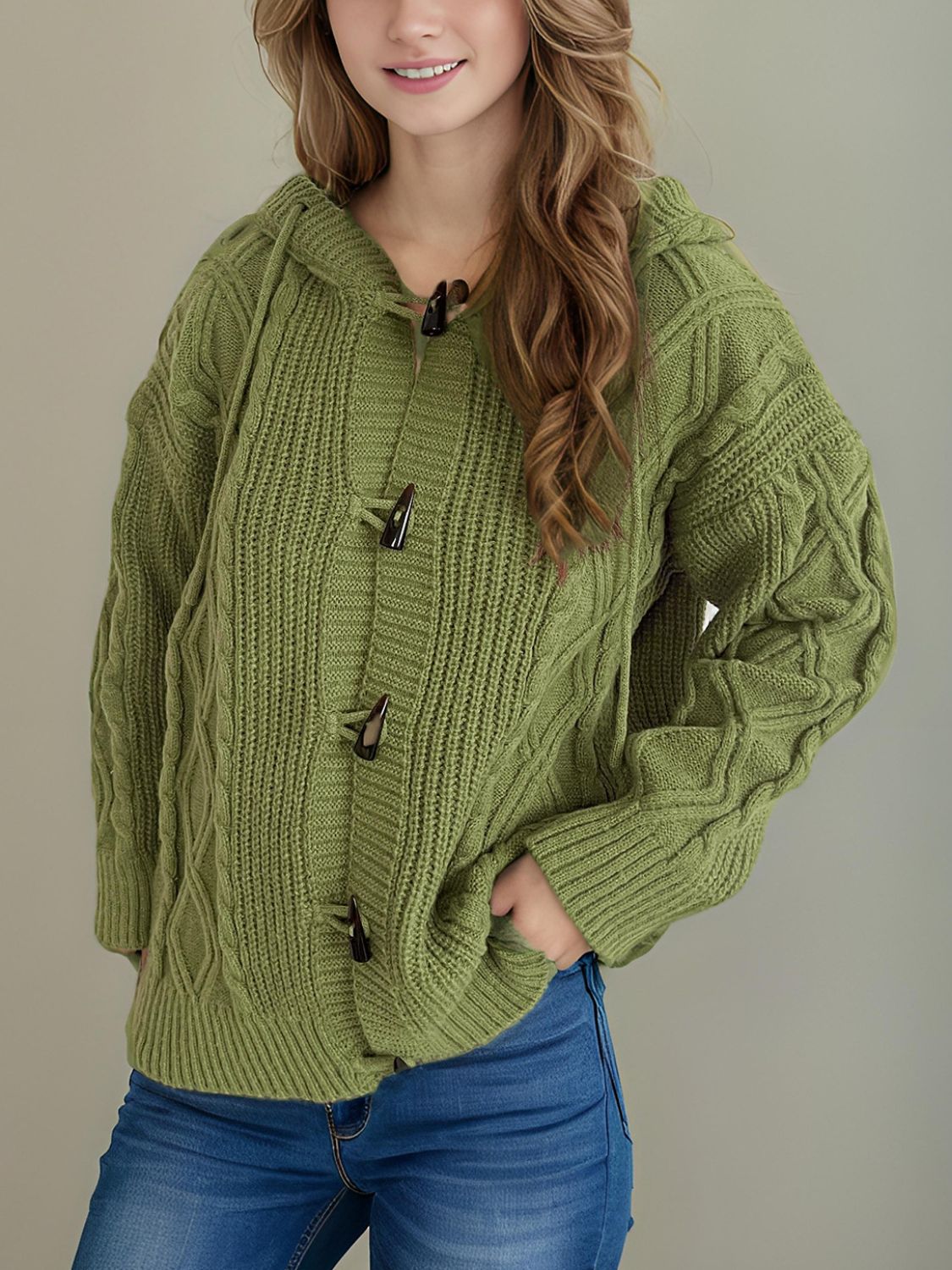 Moss green cable knit hoodie with toggle buttons and a hood.