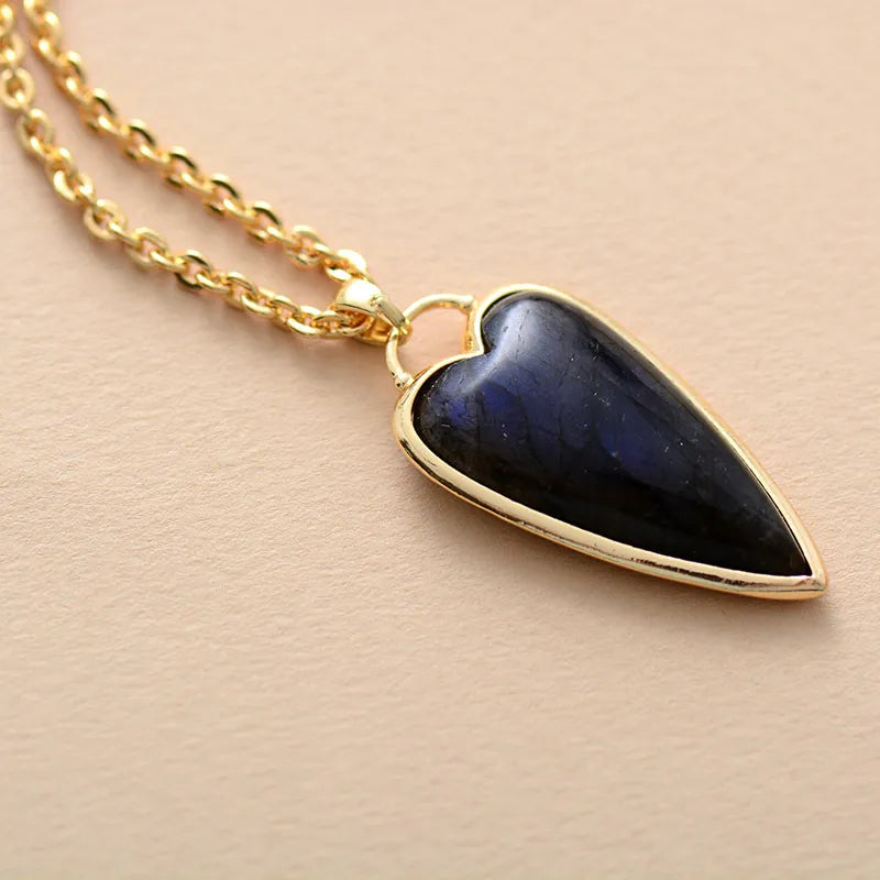Gold chain necklace with a dark blue labradorite heart pendant