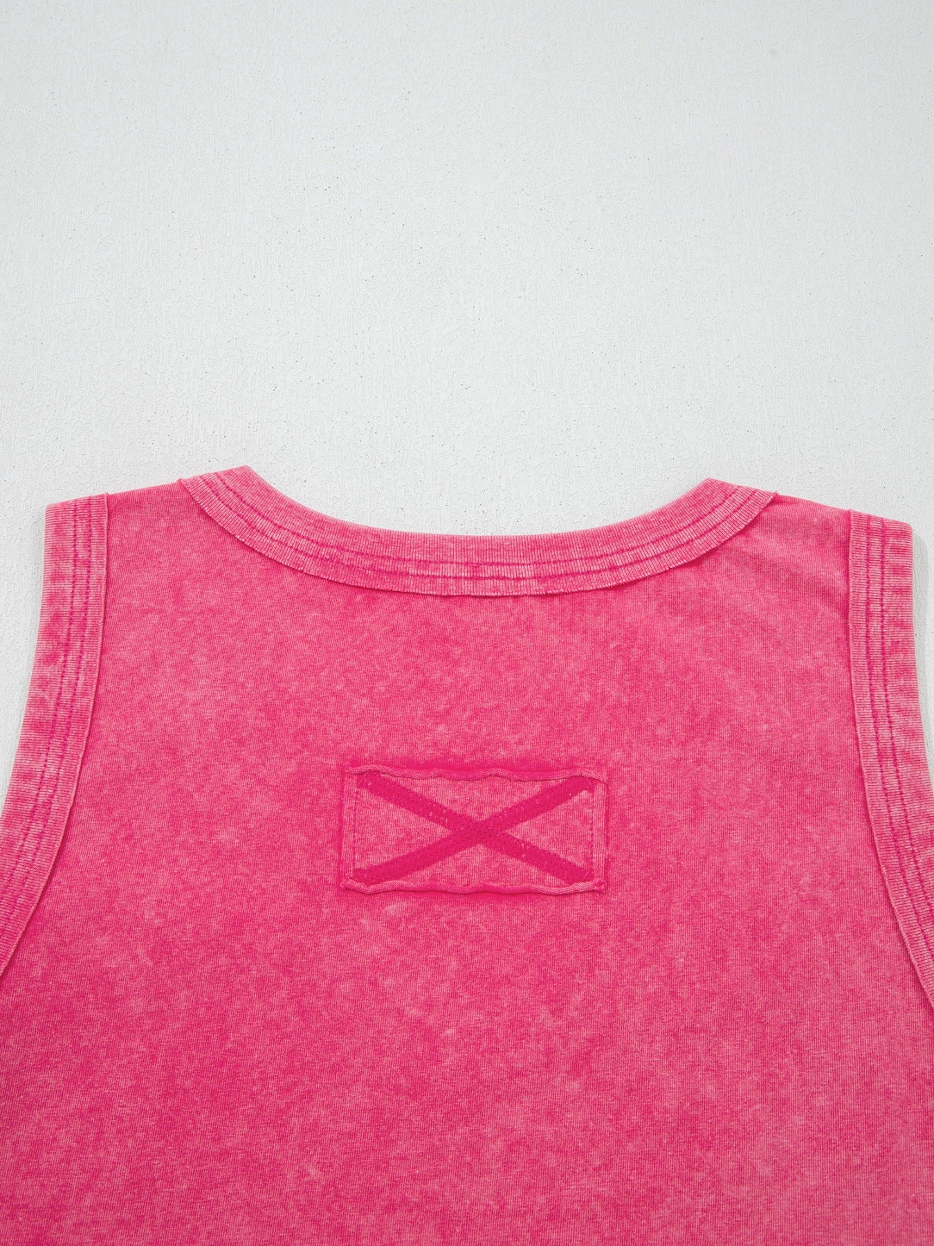 Textured cotton tank top in pink with a V-neck and a decorative X detail on a patch.