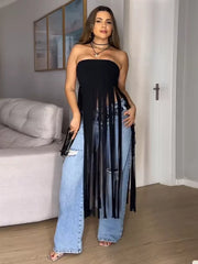 Black bohemian tube top with fringe trim, styled with ripped jeans.