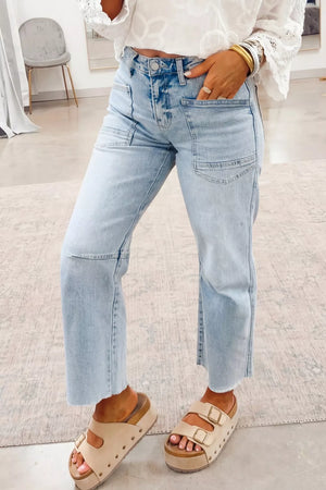 Light wash denim jeans with raw hem and utility pockets