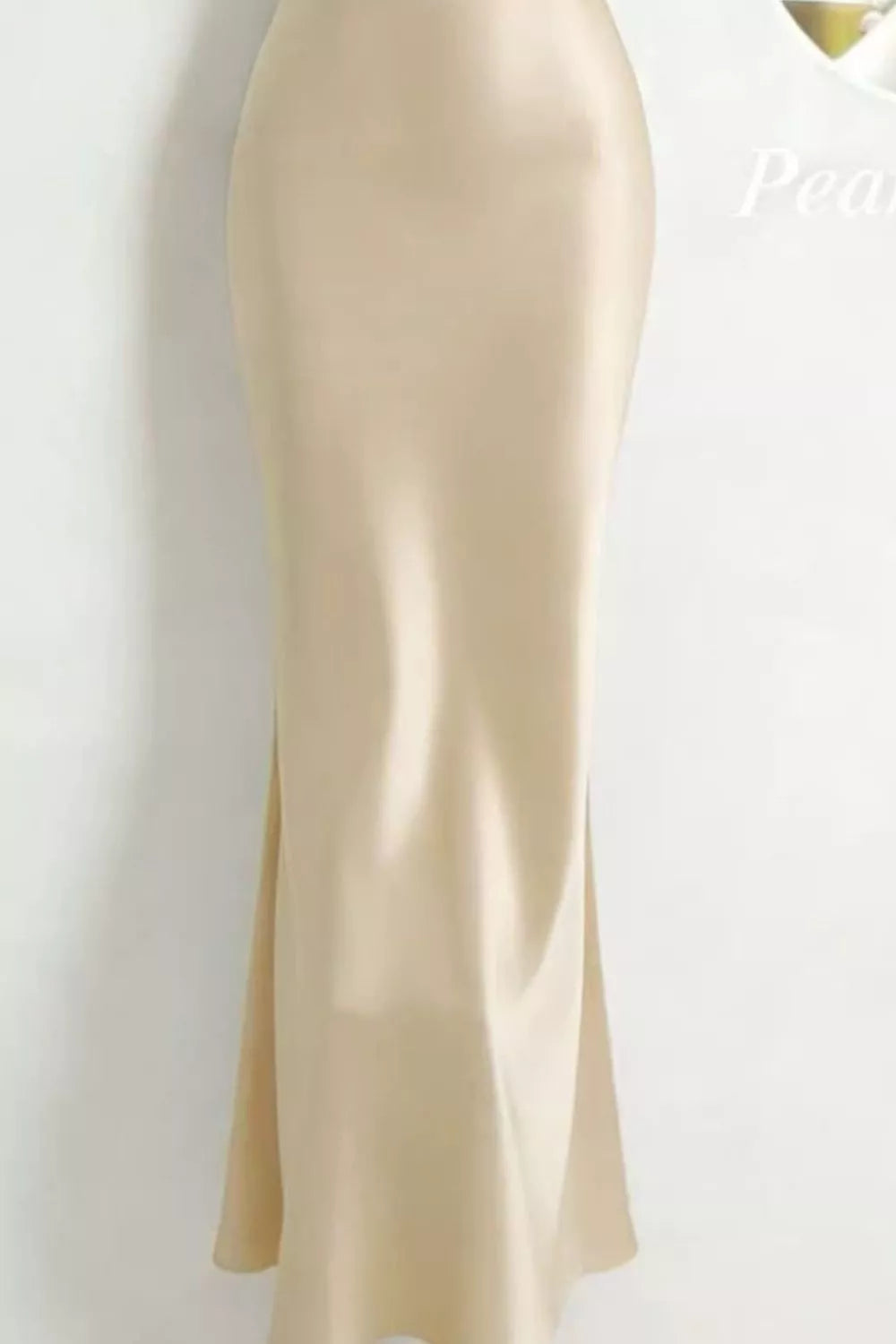 Khaki satin maxi dress with cowl neck and pearl embellishments.