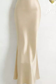 Khaki satin maxi dress with cowl neck and pearl embellishments.