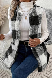 Oversized sherpa gilet in black and white buffalo check with a fuzzy texture.
