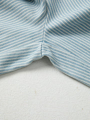 Light blue striped drawstring jeans detail showing seam and fabric texture.