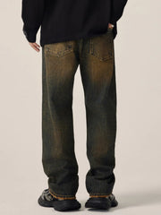 Men's relaxed fit jeans in vintage wash cotton with distressed details.