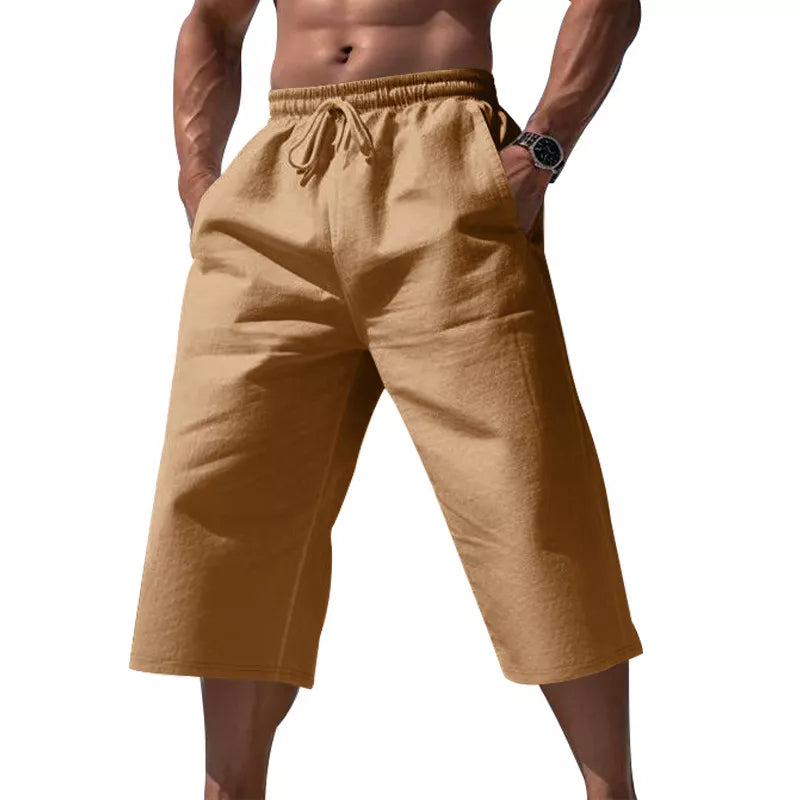 Men's cropped sweatpants in earthy yellow with drawstring waist and pockets.