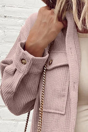 Dusty pink corduroy utility jacket with button cuffs and chest pockets.