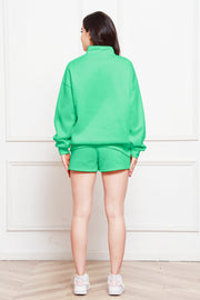 Neon Green quarter-zip loungewear set with shorts and a high neckline.