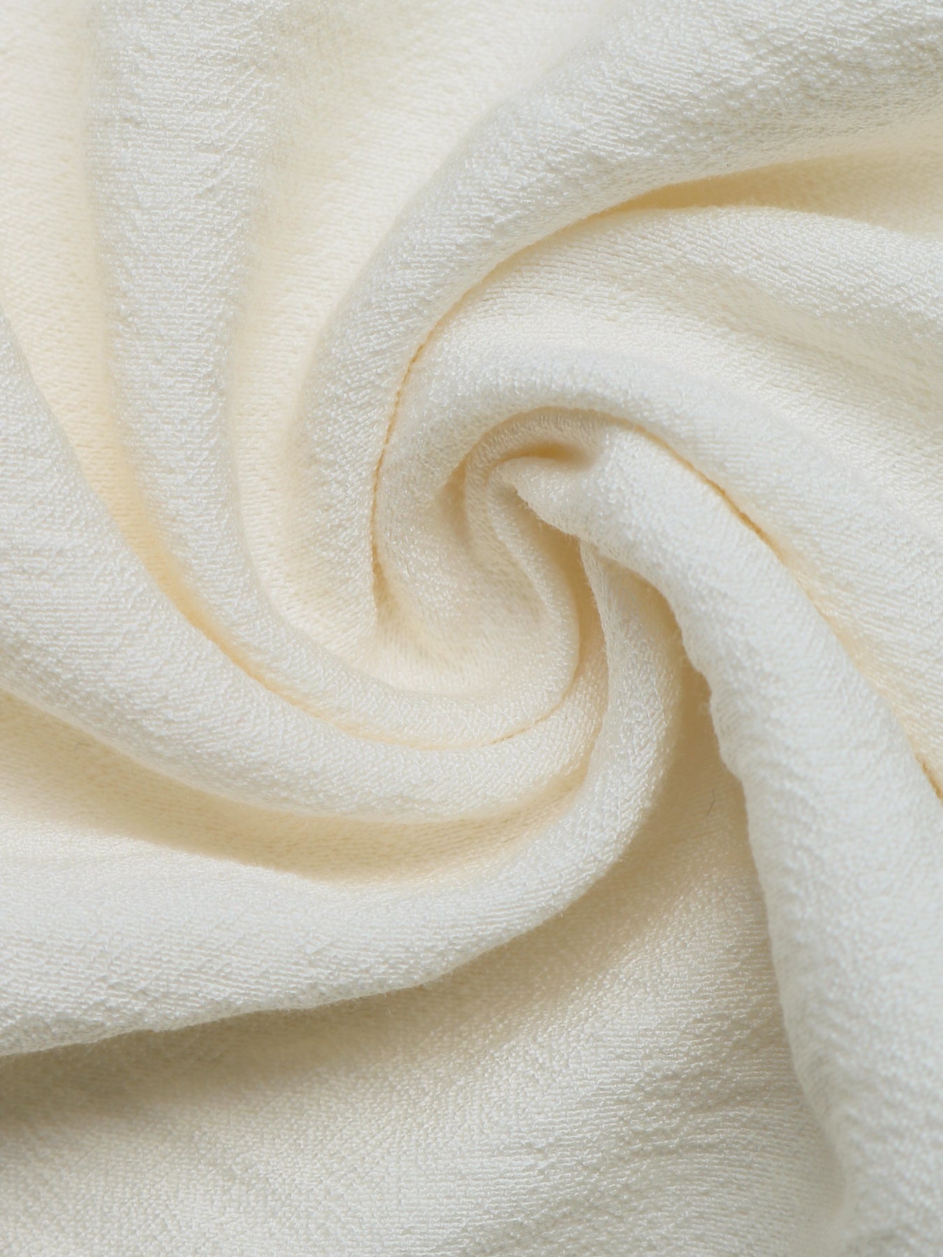 Beige tiered midi skirt fabric detail with a textured weave and wavy trim.