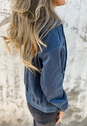 Dusty blue corduroy bomber hoodie with relaxed fit and ribbed hem.