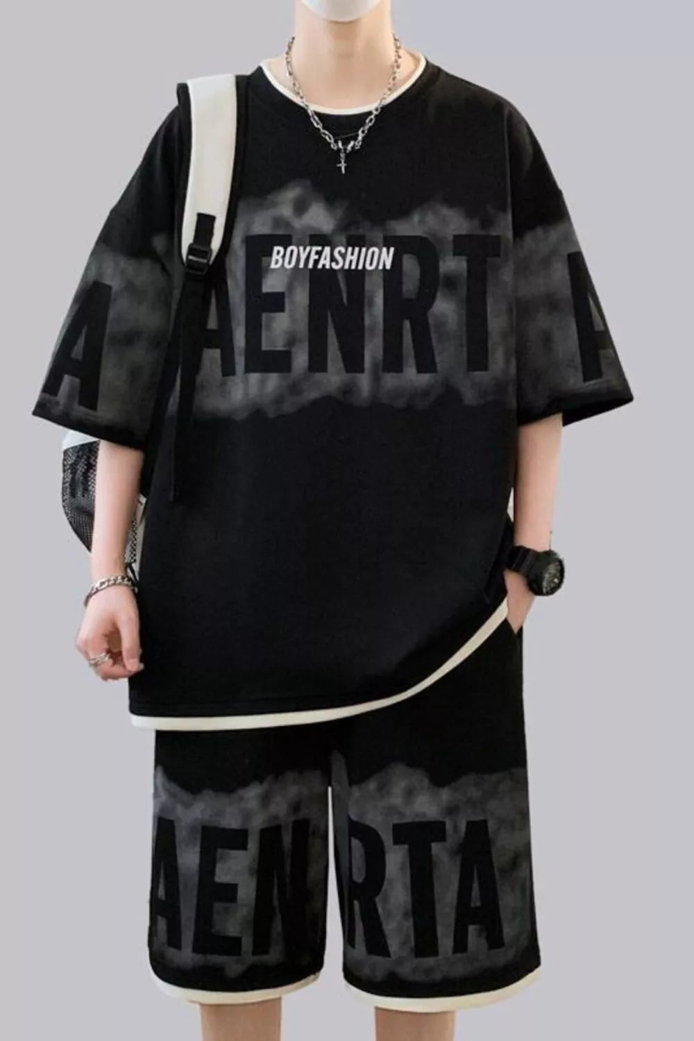 Black oversized lettered tee and shorts set with graphic print and white trim.
