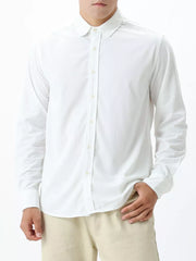 White long sleeve buttoned shirt with subtle texture and spread collar.