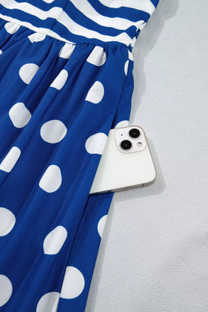 Maxi swim dress with blue and white polka dots and stripes, featuring a pocket holding a phone.