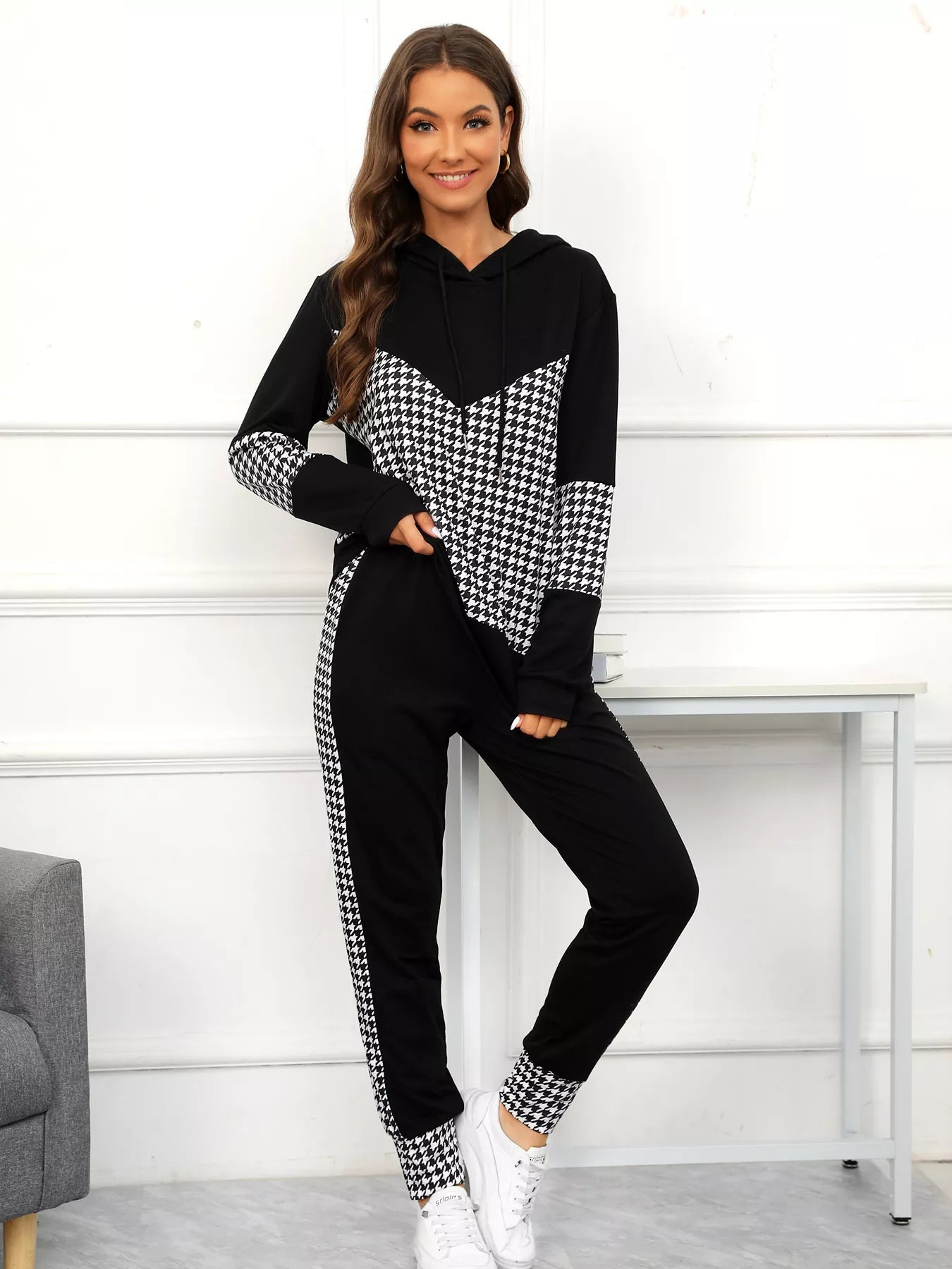 Black houndstooth hoodie and pants set with drawstring and chevron detail.