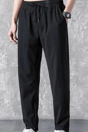 Black relaxed-fit acetate trousers with drawstring waist and pockets.
