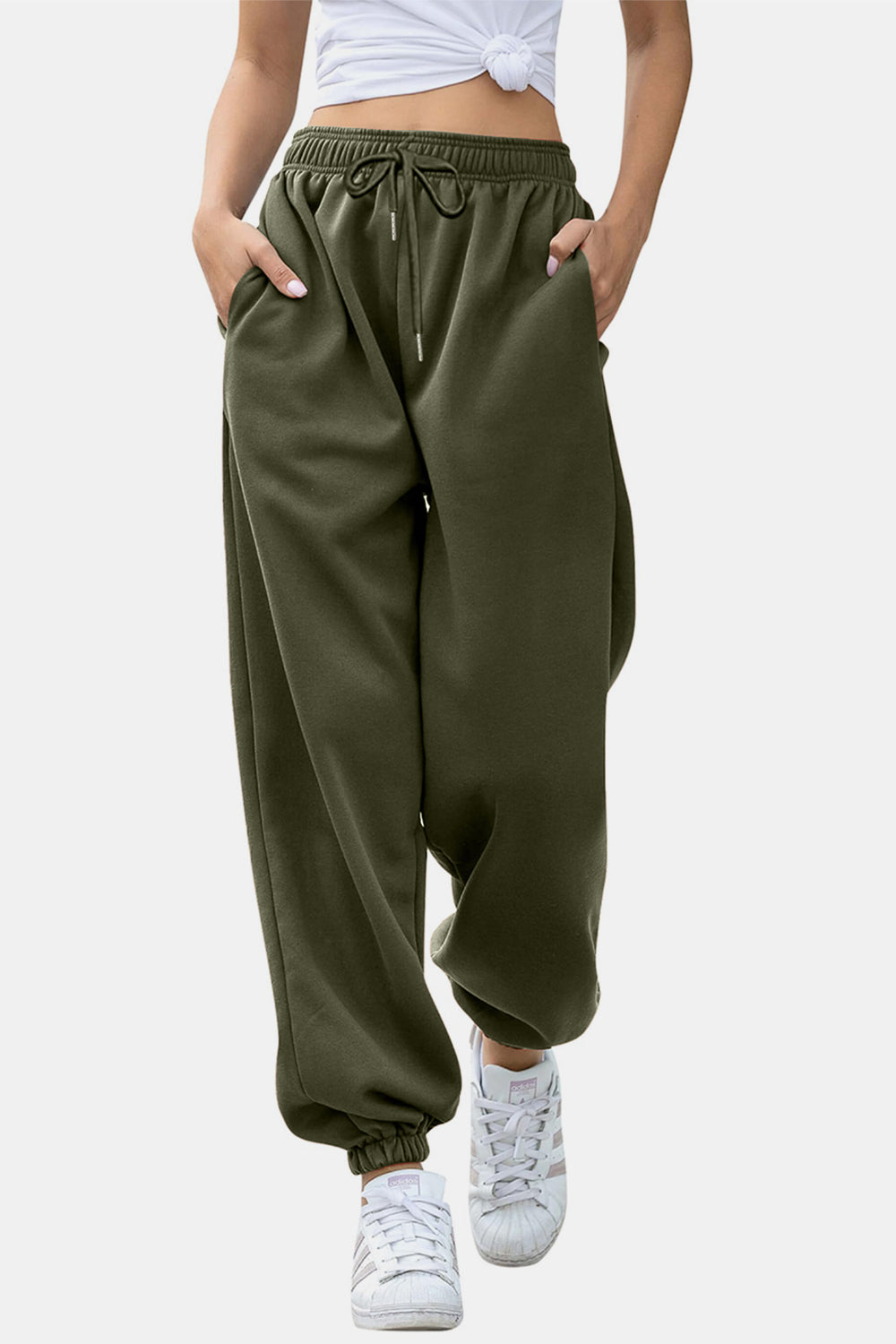 Army green sweatpants with gathered cuffs and drawstring waist.