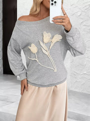 Gray boat neck sweater with floral applique detail