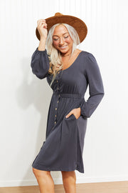 Gray button-down empire waist mini dress with V-neck, long puff sleeves, and pockets.