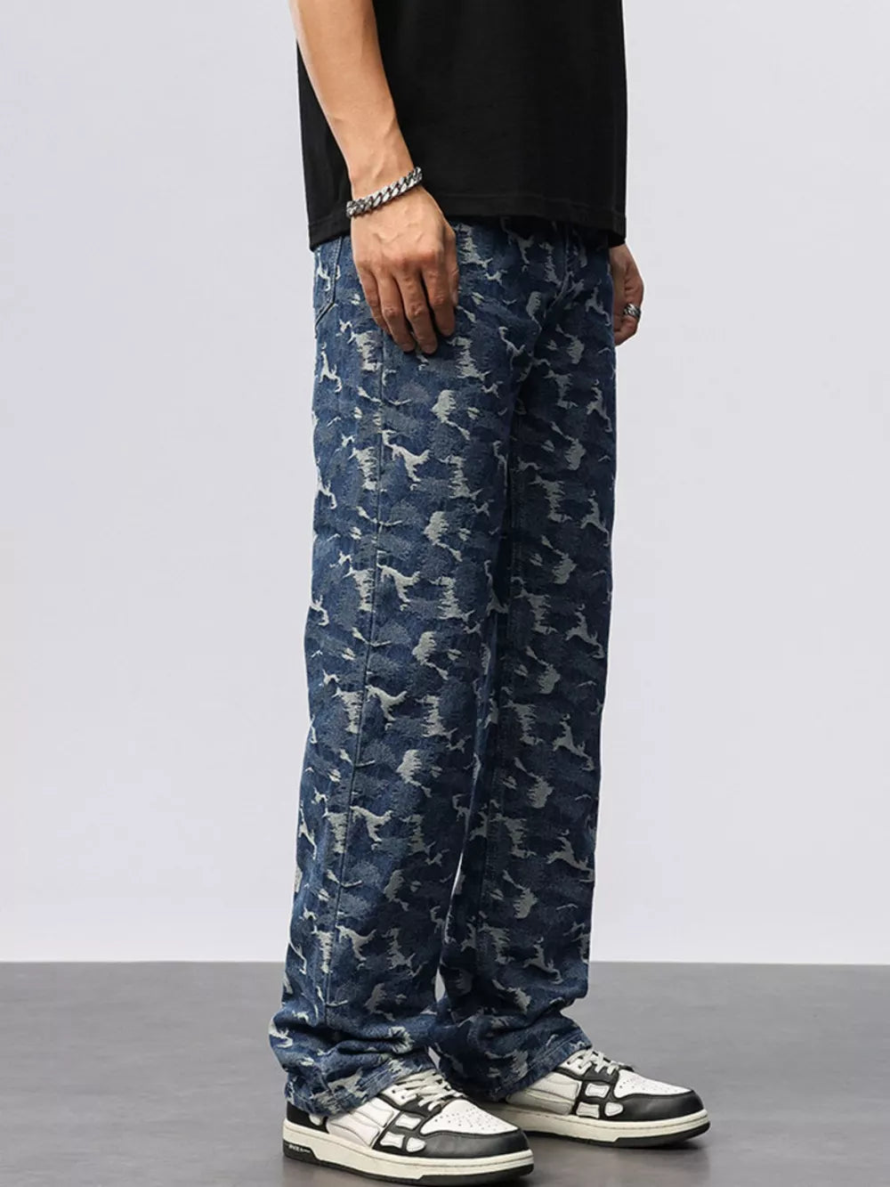 Relaxed fit blue cotton jeans with an abstract camouflage pattern