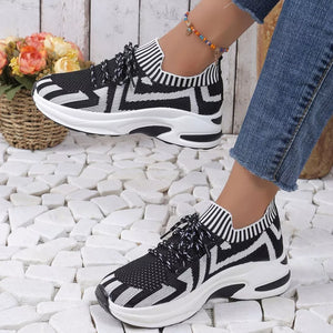 Black and white geometric knit platform sneakers with striped ankle cuff and white laces.