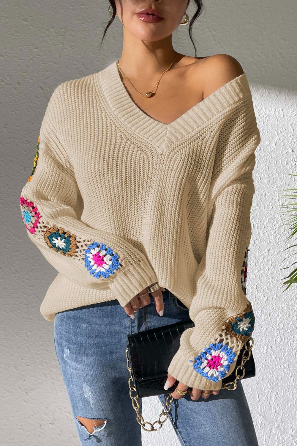 Cream v-neck sweater with colorful crochet granny square sleeve details, 100% acrylic