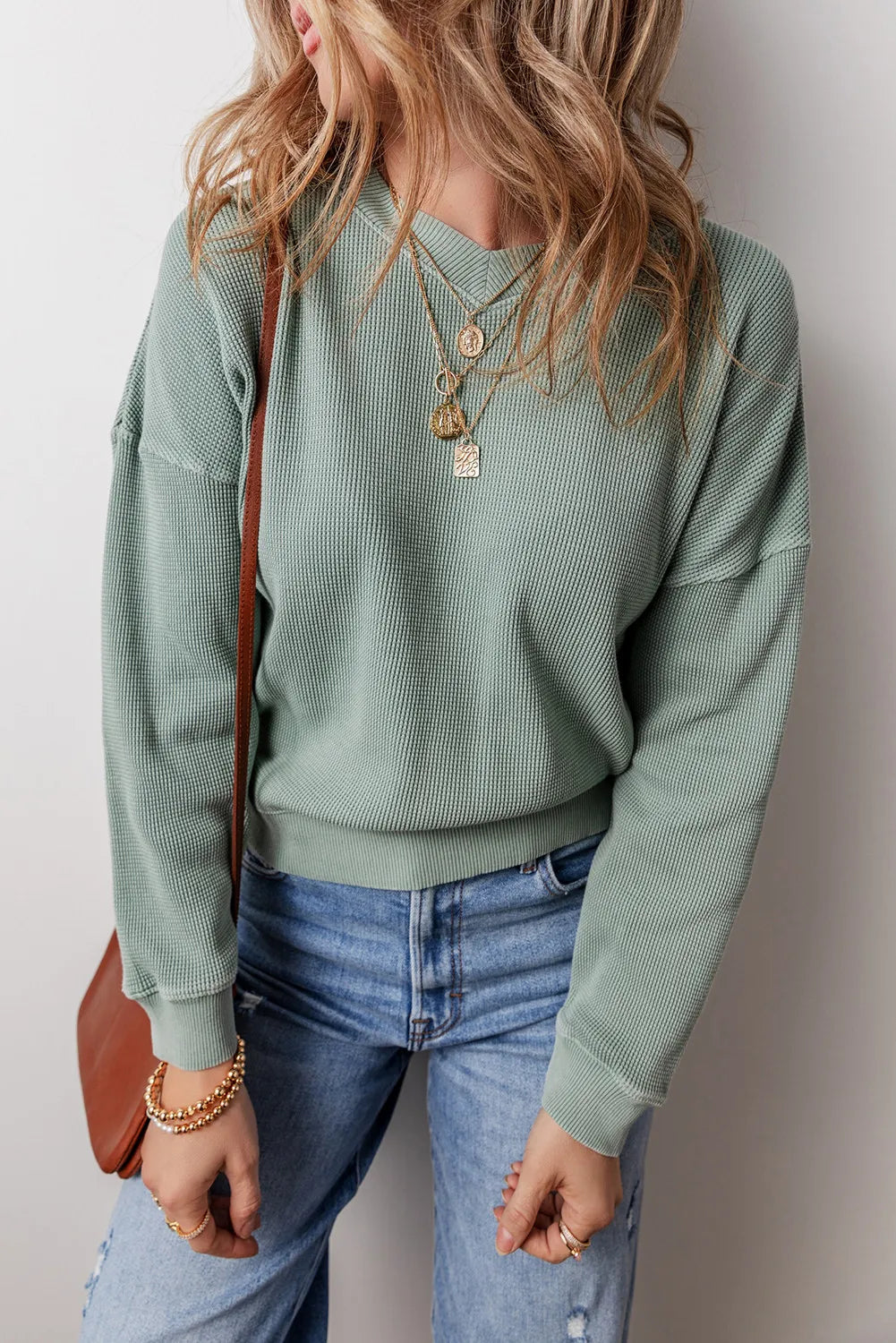 Sage waffle knit crewneck sweater with relaxed fit and crew neckline.