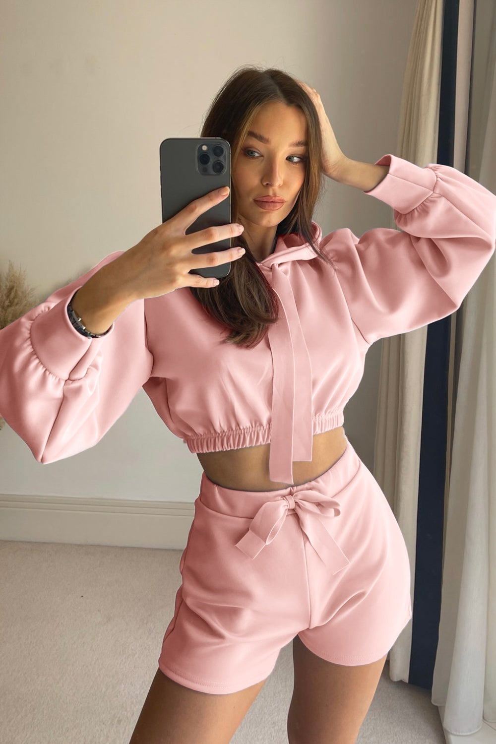 Blush pink cropped hoodie with tie detail and matching shorts with bow.