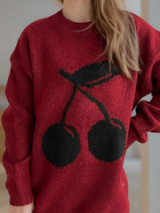 Burgundy knit sweater with black cherry motif, crew neck, long sleeves.