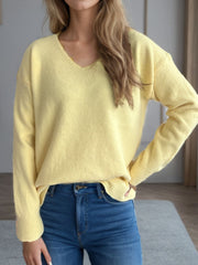 Light yellow relaxed-fit V-neck knit sweater with ribbed hem and cuffs.