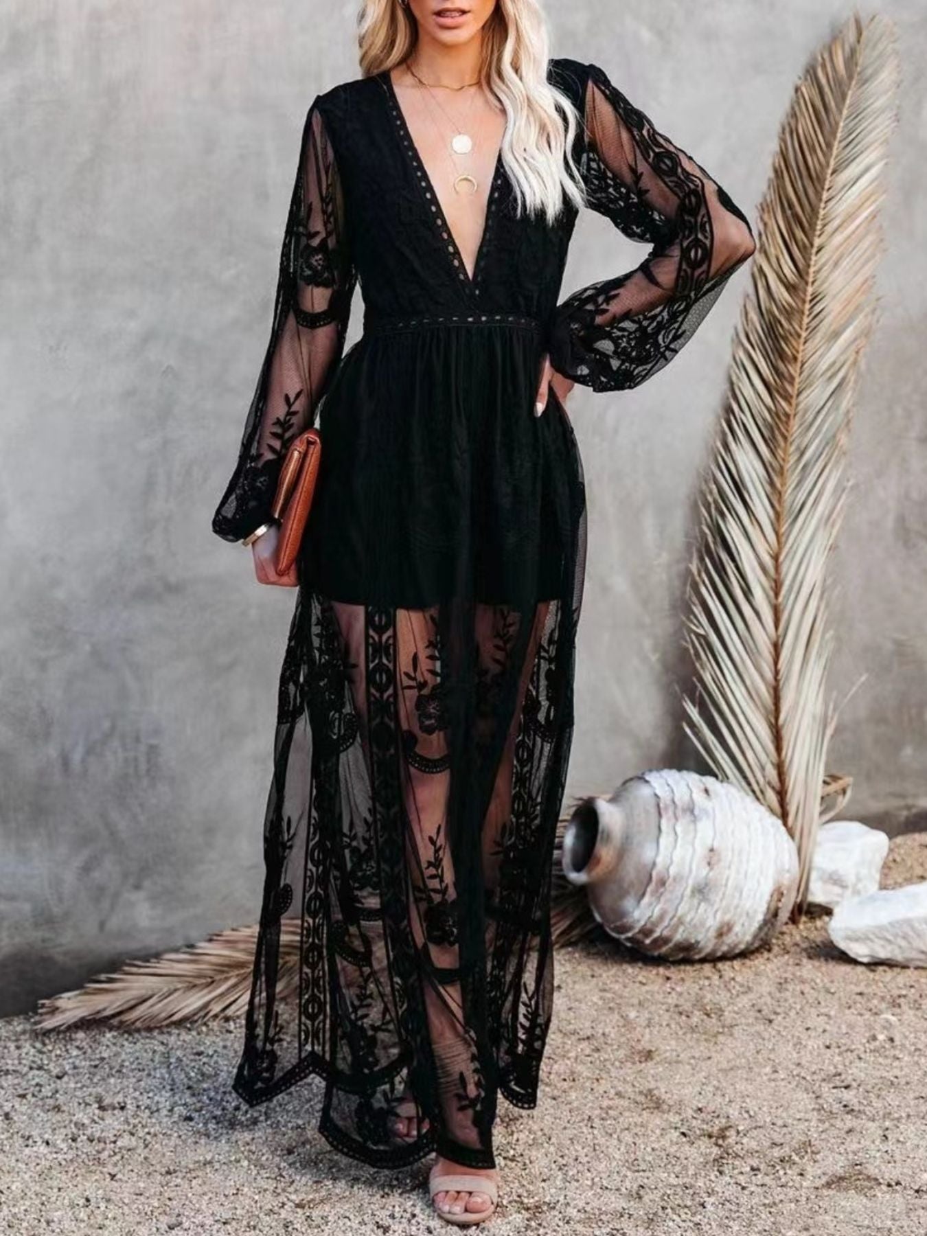 Black lace maxi dress with deep V-neck, bell sleeves, and a high slit.