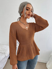 Caramel peplum knit sweater with scallop neckline and long sleeves.