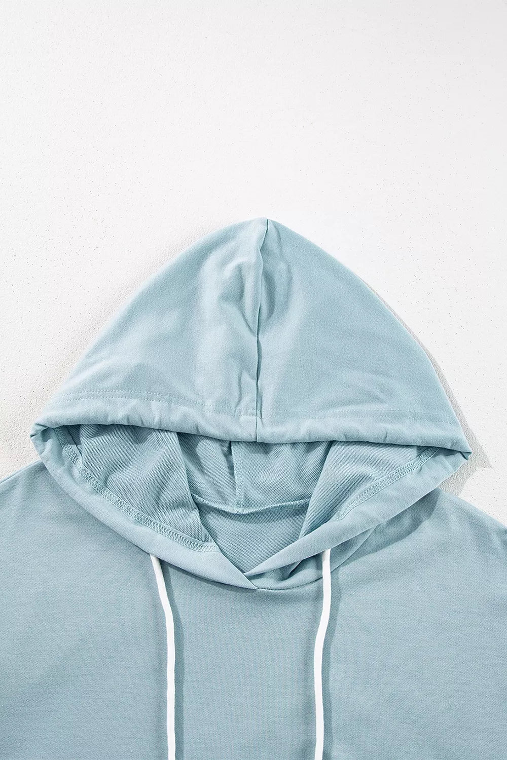 Solid Ruffled Hem Loose Fit Tunic Hoodie in Light Blue, fabric detail