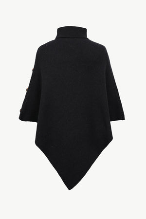 Black acrylic knit poncho with turtleneck and button details on the sleeve.